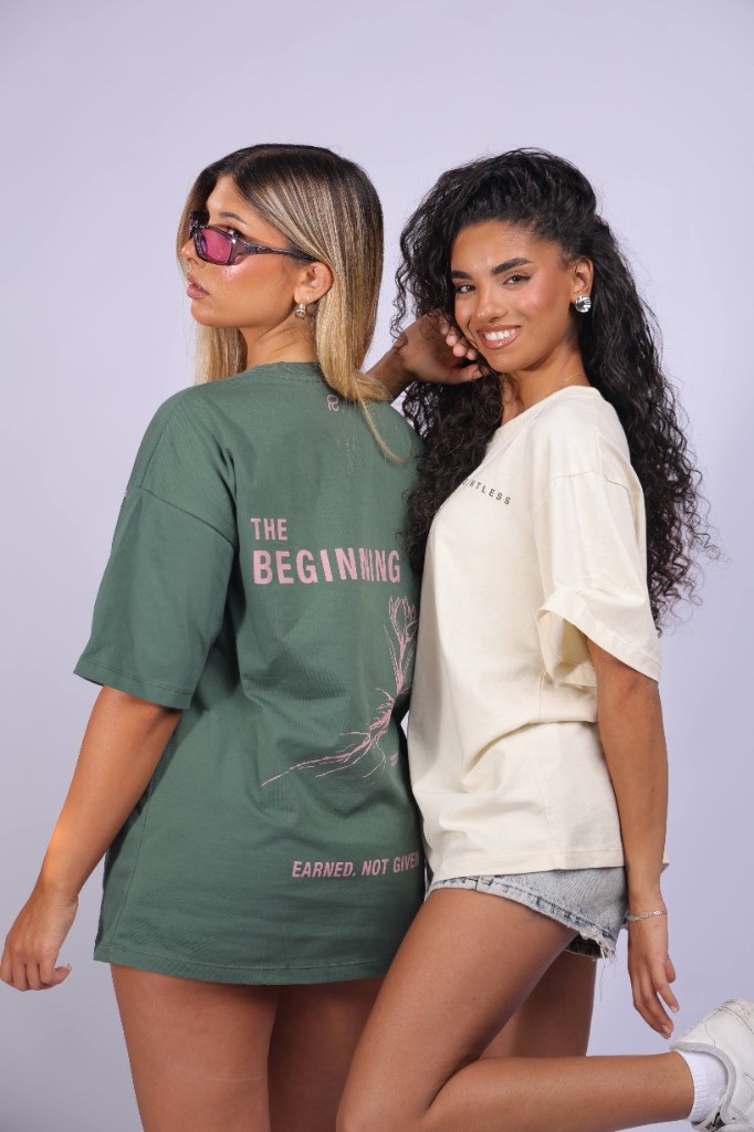 Model wearing the green Relentless tee with THE BEGINNING back print